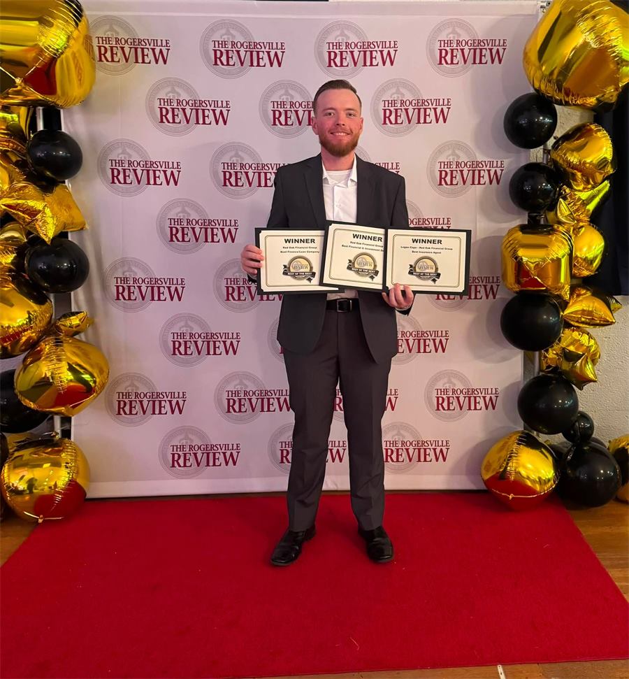 Logan Cope in a dark suit on a red carpet in front of a Rogersville Review backdrop, holding three Best of the Best 2026 winner certificates